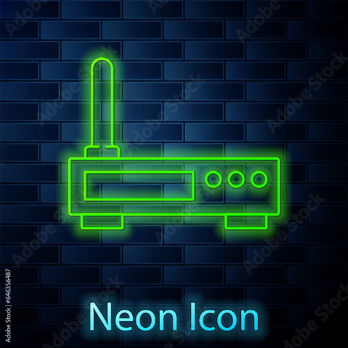 Glowing neon line Router and wi-fi signal icon isolated on brick wall background. Wireless ethernet modem router. Computer technology internet. Vector