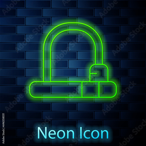 Glowing neon line Bicycle lock U shaped industrial icon isolated on brick wall background. Vector