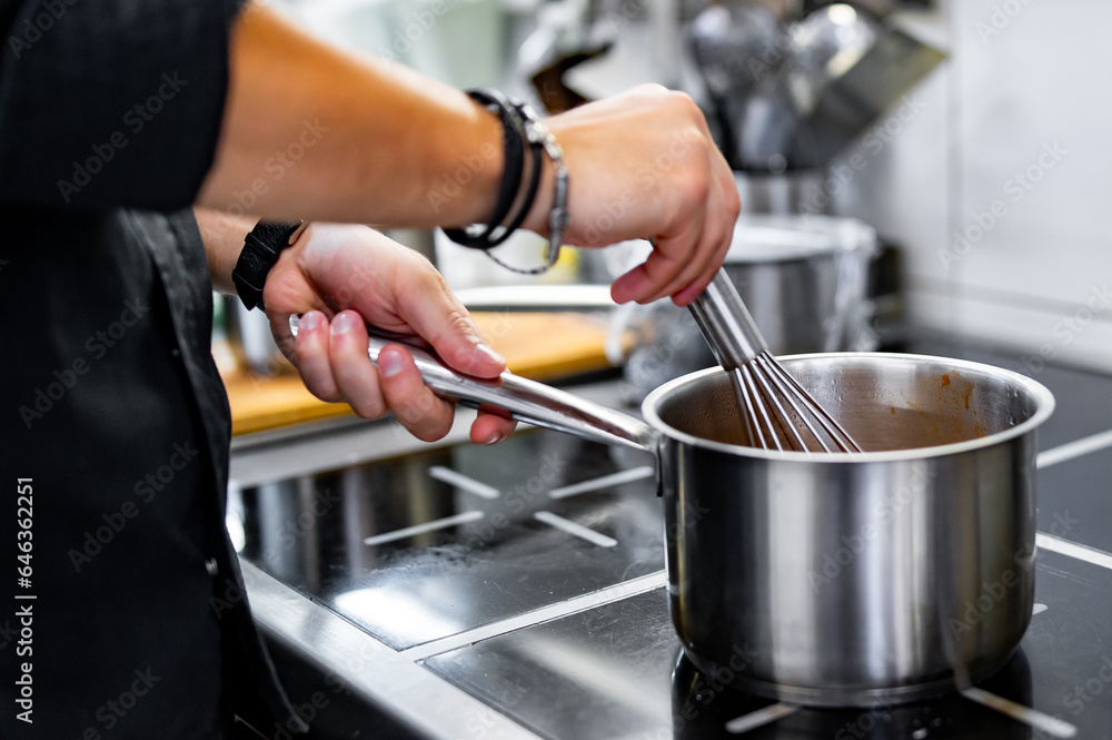 Chef cook hand cooking food at the restaurant kitchen