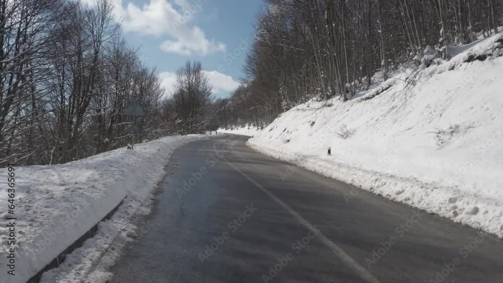 Movement of the car in the winter. A driving on snow road, to a clear sunny day. Movement of the car in the winter. A driving on snow road, to a clear sunny day.