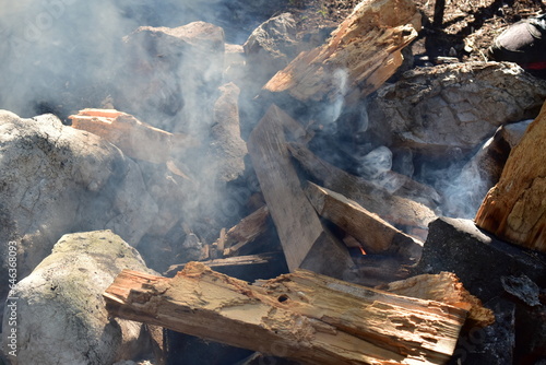 Campfire  smoke  wood and rocks. Stone and wood background nature texture.
