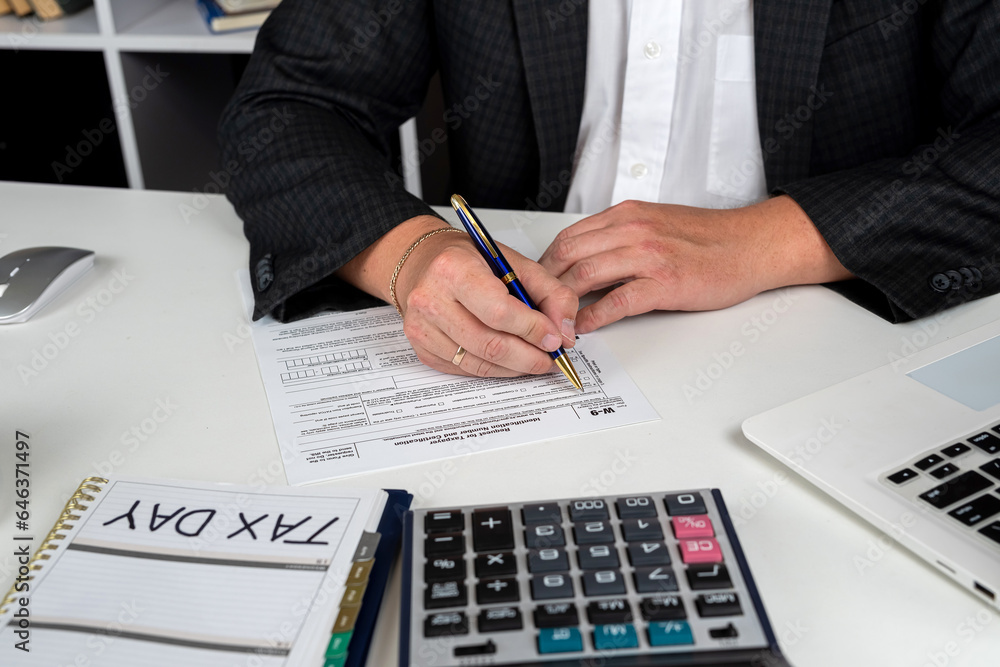 Fototapeta premium young businessman accounting and filling individual us tax form 1040