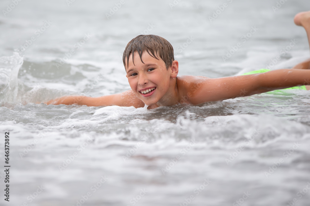 The face of a happy boy who swims in the sea. The face of a happy boy who swims in the sea.