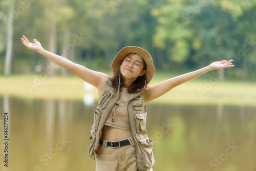 Freedom traveler girl standing with raised arms and enjoying beautiful nature.