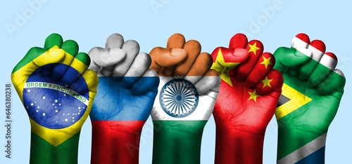 BRICS, five hands, with the flags of the countries, come together to form an economic group photo