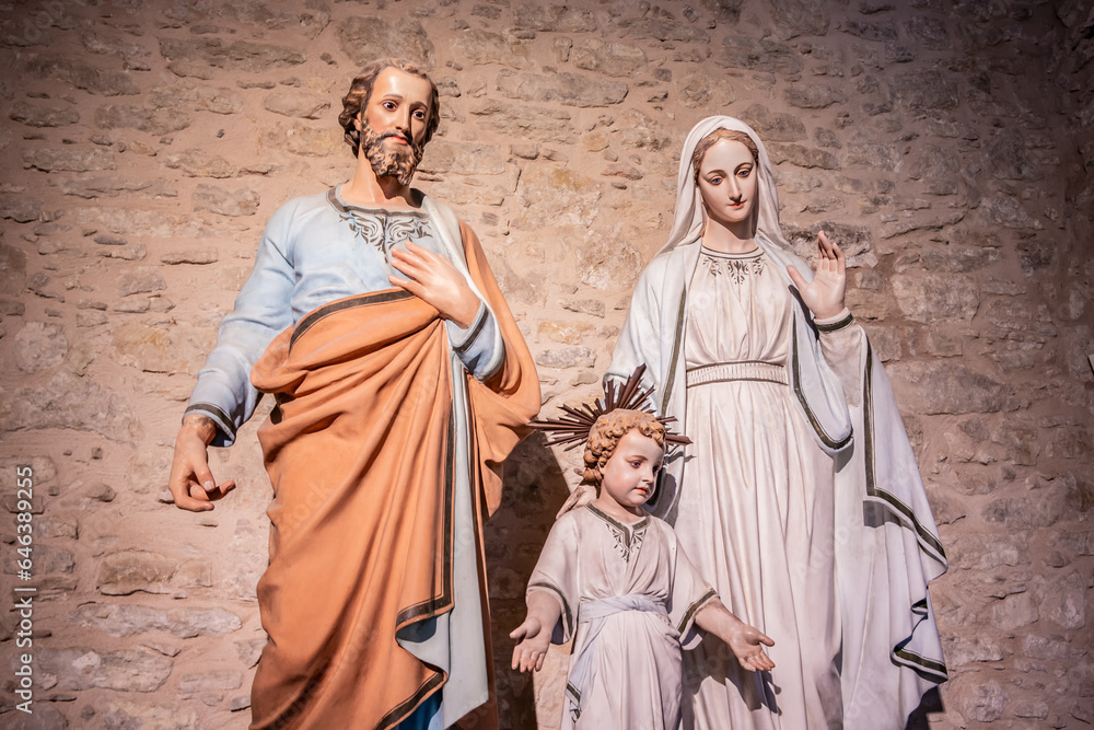 Naklejka premium Religious background with holy christian family statues