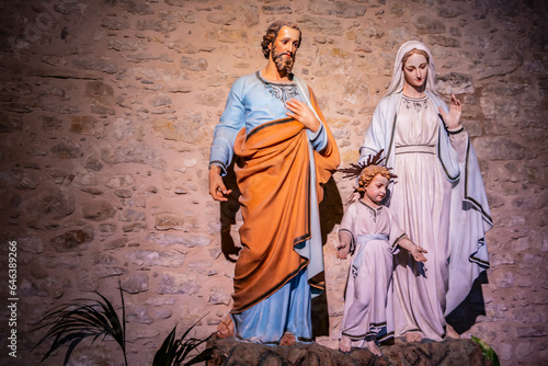 Tablou pe pânză Religious background with holy christian family statues