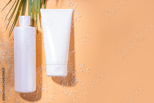 Rice Shampoo and Conditioner, organic rice water hair care. Natural beauty, organic fermented cosmetics with rice grains on background copy space