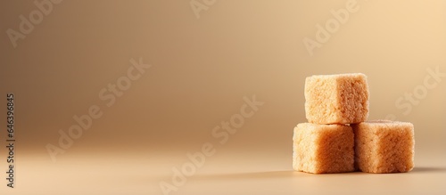 Caramelized brown sugar cube on a isolated pastel background Copy space