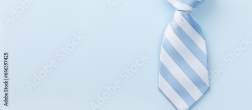 Blue and white striped tie against isolated pastel background Copy space