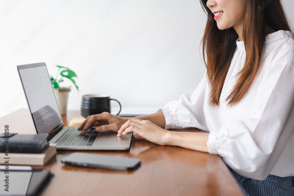 Businesswomen typing data on keyboard of laptop and working about new startup in outside office