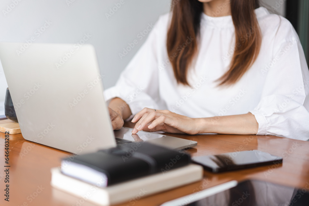 Businesswomen typing data on keyboard of laptop and working about new startup in outside office Businesswomen typing data on keyboard of laptop and working about new startup in outside office
