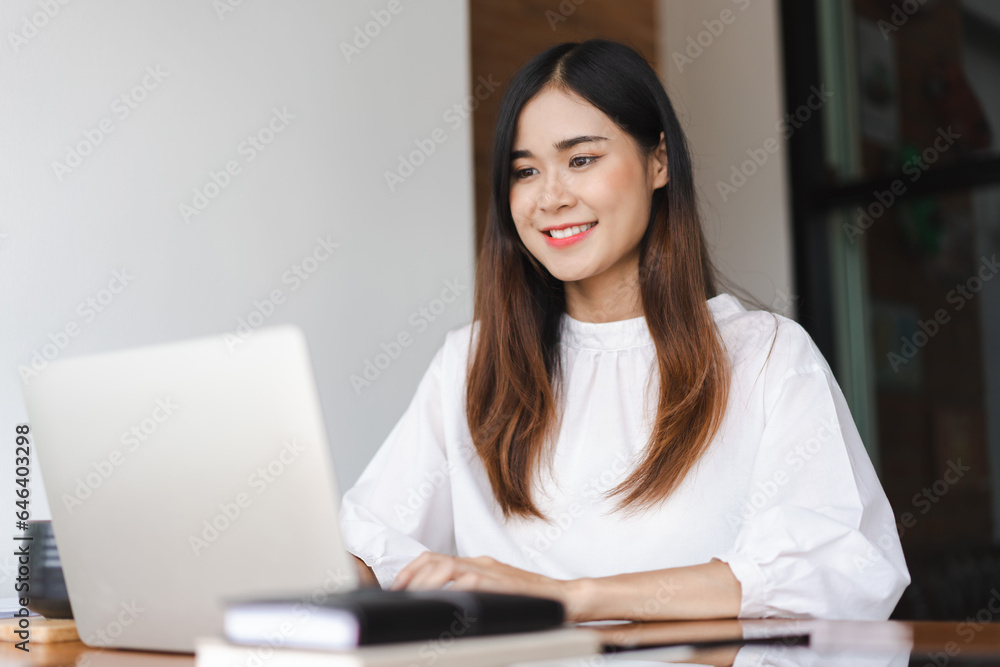Businesswomen typing data on keyboard of laptop and working about new startup in outside office Businesswomen typing data on keyboard of laptop and working about new startup in outside office