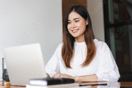 Businesswomen typing data on keyboard of laptop and working about new startup in outside office