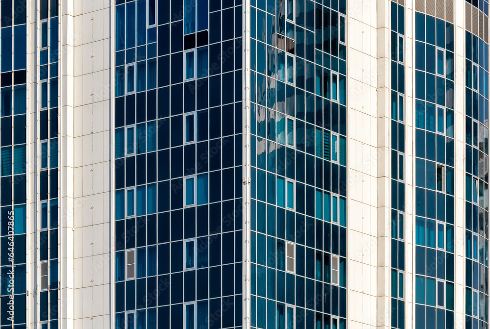 many windows and walls facade of a modern skyscraper without people many windows and walls facade of a modern skyscraper without people