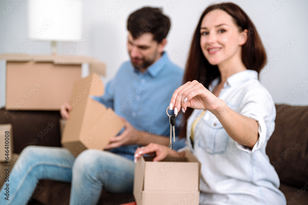 Young woman hand holding keys from property, ownership concept. Young woman hand holding keys from property, ownership concept.