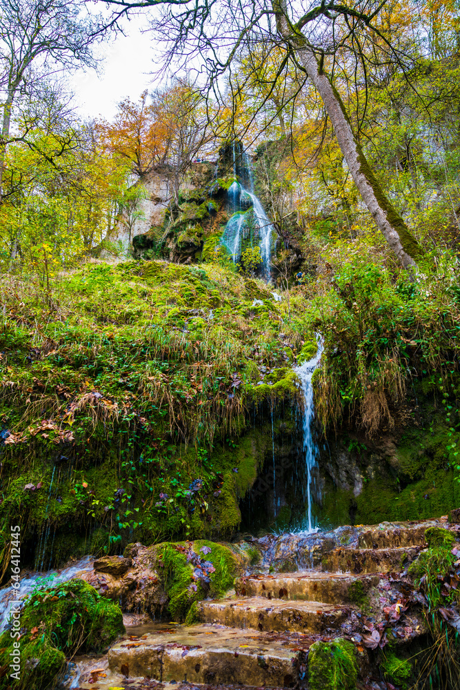 Germany, Colors of autumn forest trees nature landscape bad urach waterfall destination on swabian alb nature reserve