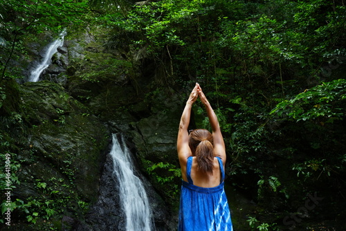 Woman standing in Yoga Position at Kijoka Seven Falls in Okinawa -                                                                      