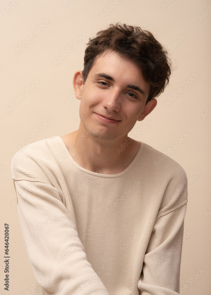portrait of a young man in a light pullover posing for the camera, different emotions, on a light background portrait of a young man in a light pullover posing for the camera, different emotions, on a light background