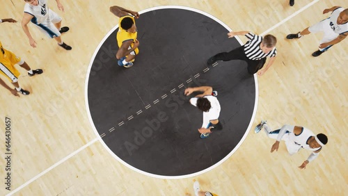 College Basketball Playoffs: White Team Player Winning Face-Off Opening Tip From a Rival Team Player. Slow Motion Top View Cinematic Footage from a Live TV Replay on a Sports Channel