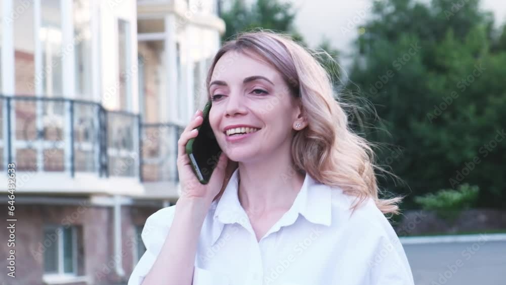 a fasion pretty bisness woman is calling someone by mobile phone outdoor. a fasion pretty bisness woman is calling someone by mobile phone outdoor.