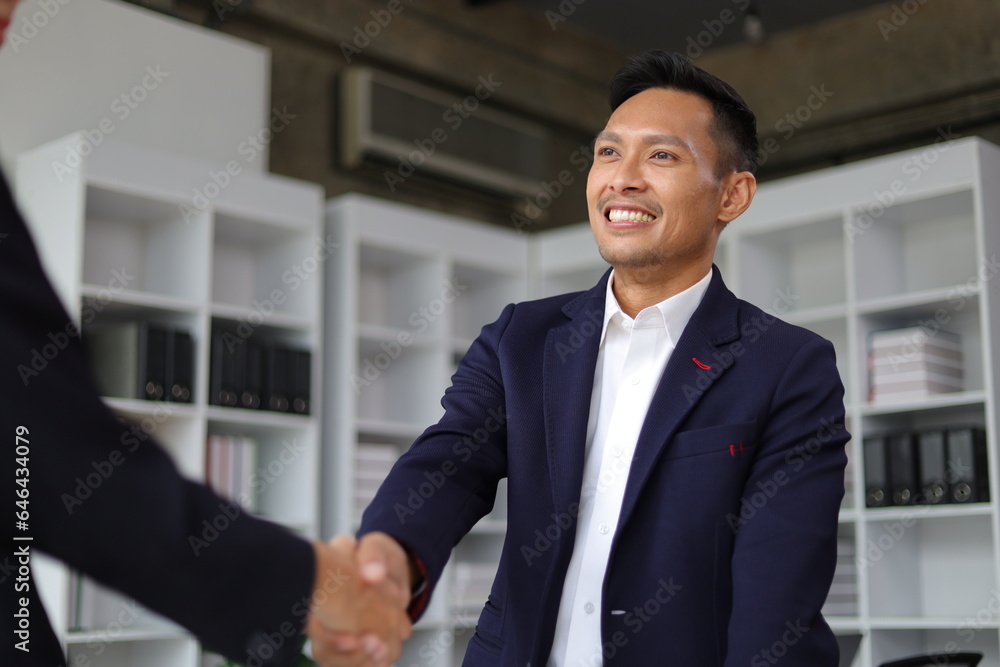 Business partners and colleagues shaking hands at work cooperation. Job applicant shaking hands with executives in office room at job interview. Business partners and colleagues shaking hands at work cooperation. Job applicant shaking hands with executives in office room at job interview.