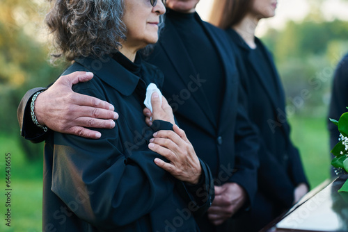 Obraz na plátně Hand of mature man on shoulder of his wife or sister with handkerchief lamenting