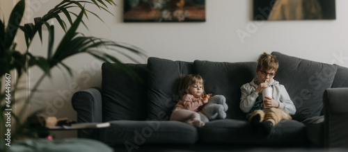 Children spending time indoors while raining during summer break. photo