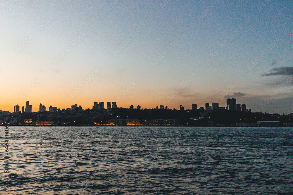 View of bosphorus strait water at sunset with low light and skyline