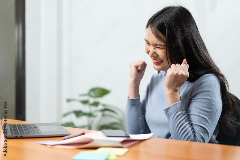 young woman Cheerful and successful businesswoman celebrating with great satisfaction in the company young woman Cheerful and successful businesswoman celebrating with great satisfaction in the company