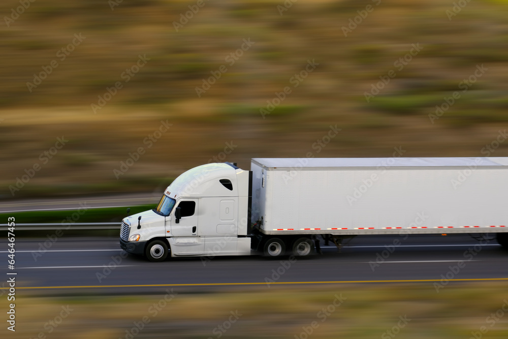 Semi Truck and Trailer Speeding Down Highway Road Blurred Blurry