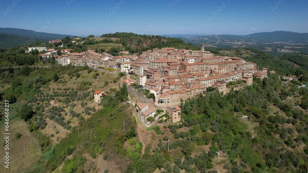 Drone flying over a magnificent authentic tuscany cityscape. Aerial view of the beautiful medieval historic center of Chiusdino, an Italian municipality in the province of Siena in Tuscany.