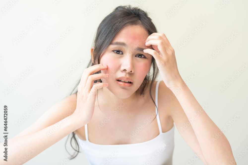 Dermatology, scratch asian young woman looking at mirror, expression worry and itch, itchy allergy or allergic sensitive reaction, red spot or rash on her face. Beauty care from skin problem treatment