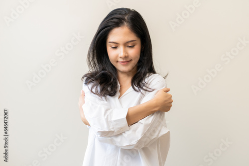 Photography Smiling positive, hugging oneself happy asian young woman hands hug herself shoulders enjoy joyful, self hugging, self love and self care, face expression self esteem standing isolated on background
