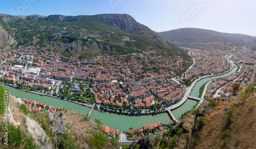 Amasya, Turkey - july 22, 2023 : Old Ottoman houses panoramic view by the Yesilirmak River in Amasya City. Amasya is populer tourist destination in Turkey.