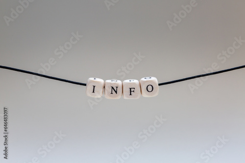Concept of information, info sign over light grey background on a string

