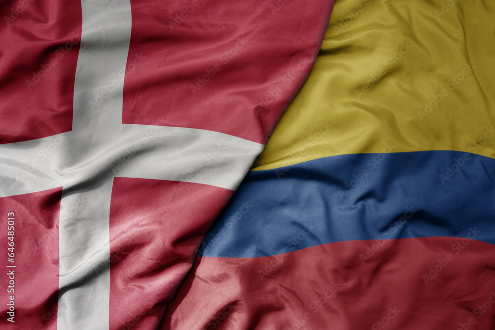 big waving national colorful flag of denmark and national flag of colombia .