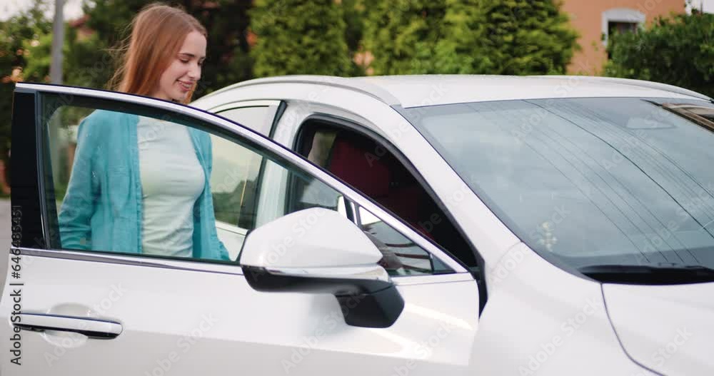 Beautiful young woman coming to white car, opening driver door, sitting inside and closing door. Beautiful young woman coming to white car, opening driver door, sitting inside and closing door.
