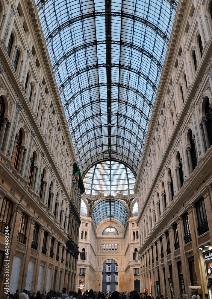 Explore the perfectly symmetrical perspective of the magnificent vaulted architecture inside Galleria Umberto I in Naples, Italy