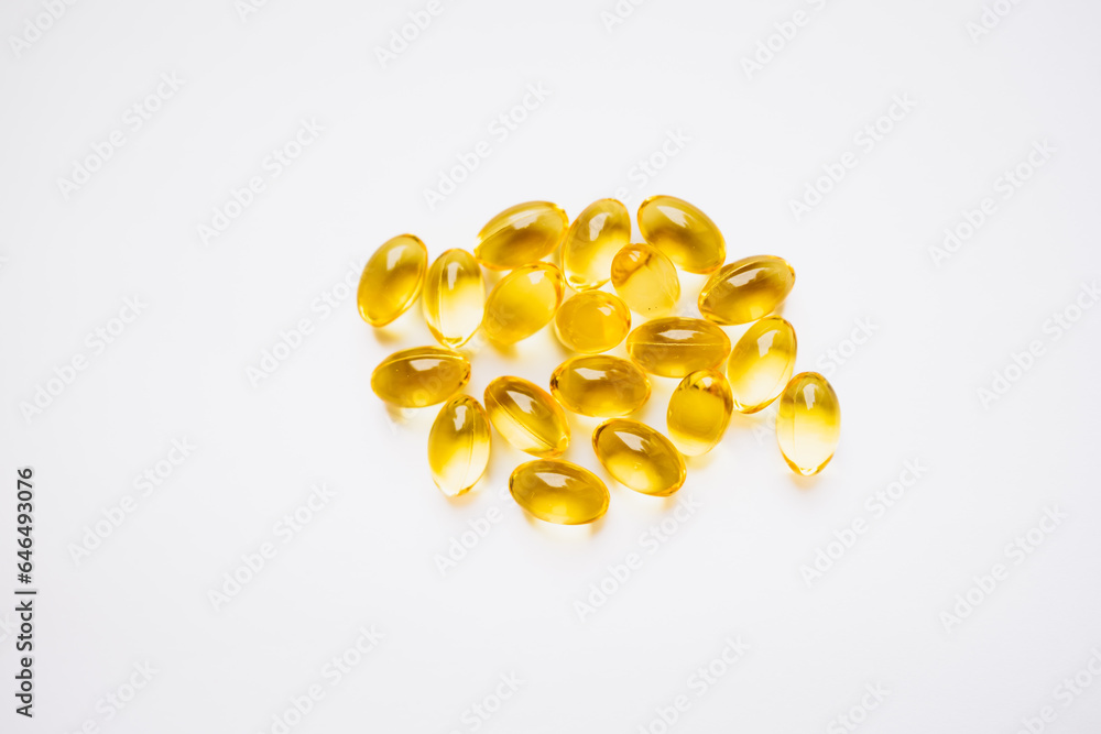 Fototapeta premium yellow capsules on a white background. medicines and vitamins