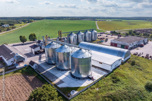 aerial panoramic view on agro-industrial complex with silos and grain drying line for drying cleaning and storage of cereal crops