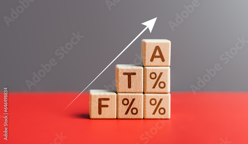 FTA text in wooden block and increase percentage. Free trade agreement, economy, planning, interest, opportunity, Ministry of Finance, government, international finance, business, financial concept.