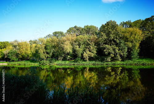 City lake in autumn park landscape background