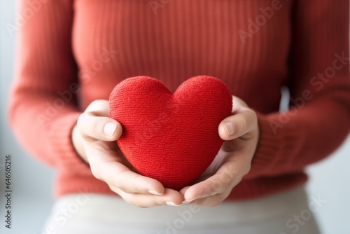 Red heart in womens hand