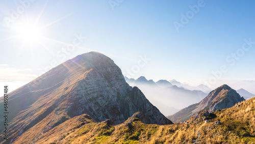 Stunning scene of a mountain ridge  hills  and tops in the morning mist at daybreak  aerial shot. Travel  nature  and environmental conservation concepts.