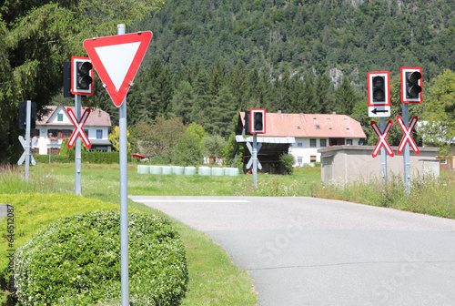 Fotografie road signs of attention to the train level crossing on the rails of the railway