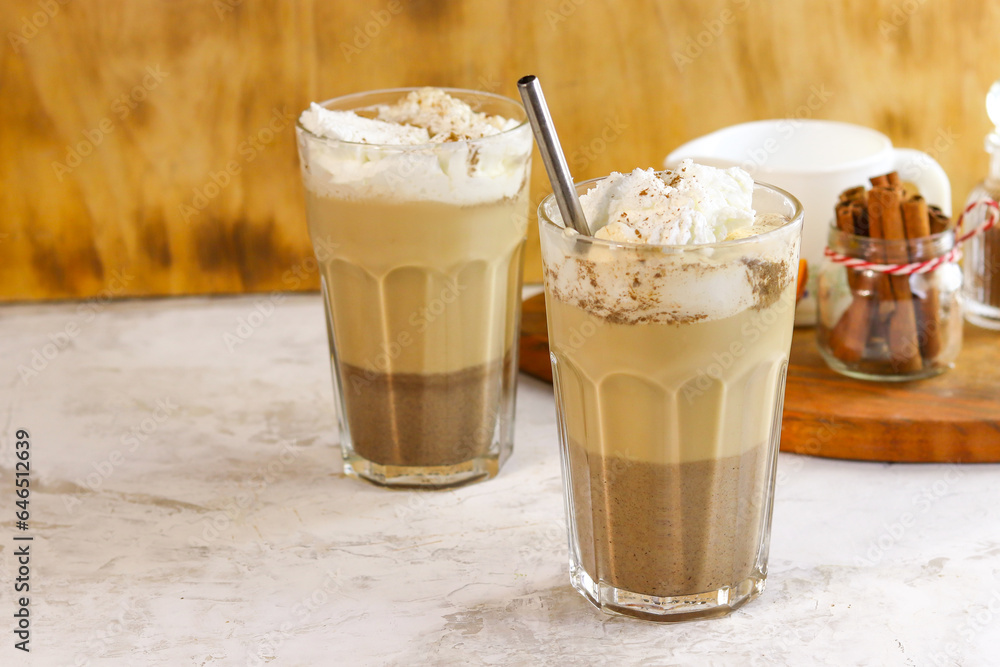Coffee with whipped cream in a glass glass on a brown background Coffee with whipped cream in a glass glass on a brown background