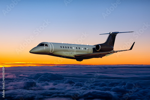 Modern luxury business jet fly in the sunrise sky