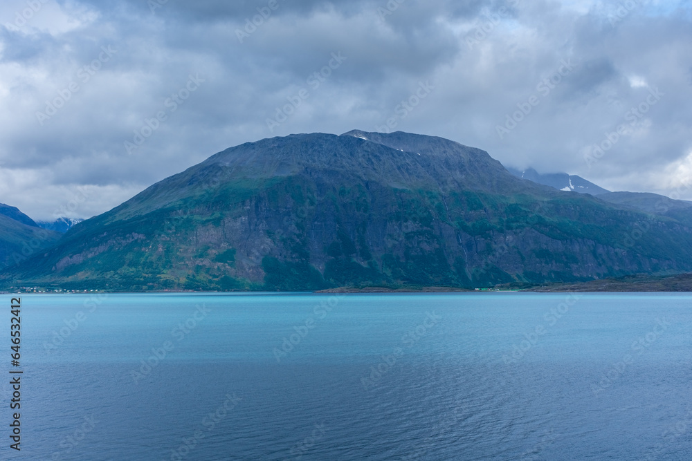 Beautiful  view over a Norwegian fjord from the sea with turquoise water between the mountains