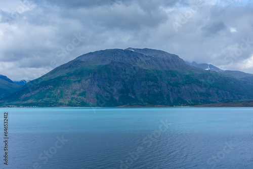 Beautiful view over a Norwegian fjord from the sea with turquoise water between the mountains